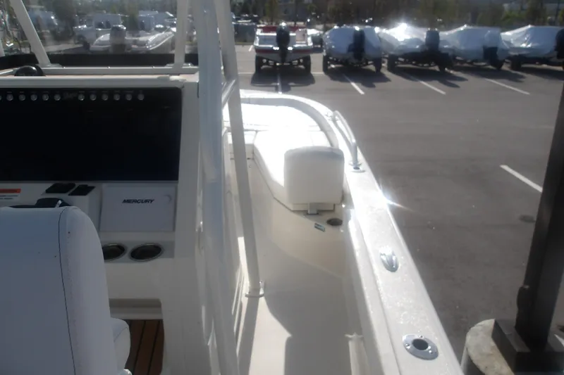 Slide: The Image of 2025 Ranger 2360 Bay boat interior with Mercury controls in a parking lot. - 10