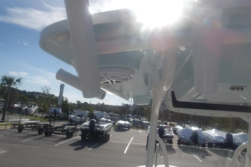 Slide: The Image of 2025 Ranger 2360 Bay boat in sunny marina, showcasing sleek design and modern features. - 25