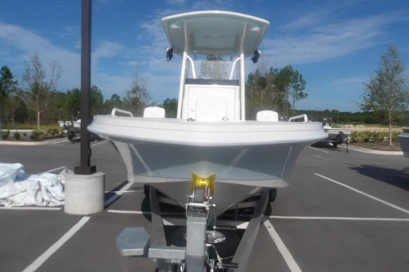 Slide: The Image of 2025 Ranger 2360 Bay boat on trailer in parking lot, clear sky background. - 15