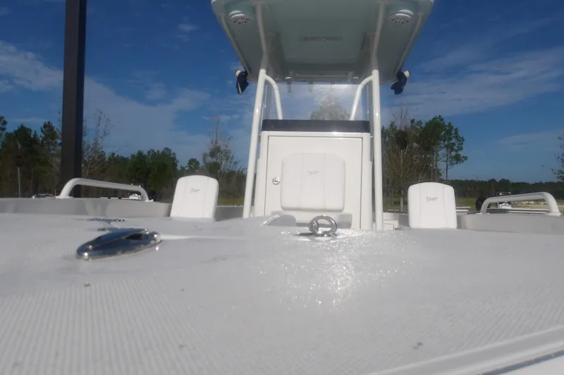 Slide: The Image of 2025 Ranger 2360 Bay boat deck with seating, under a clear blue sky. - 3