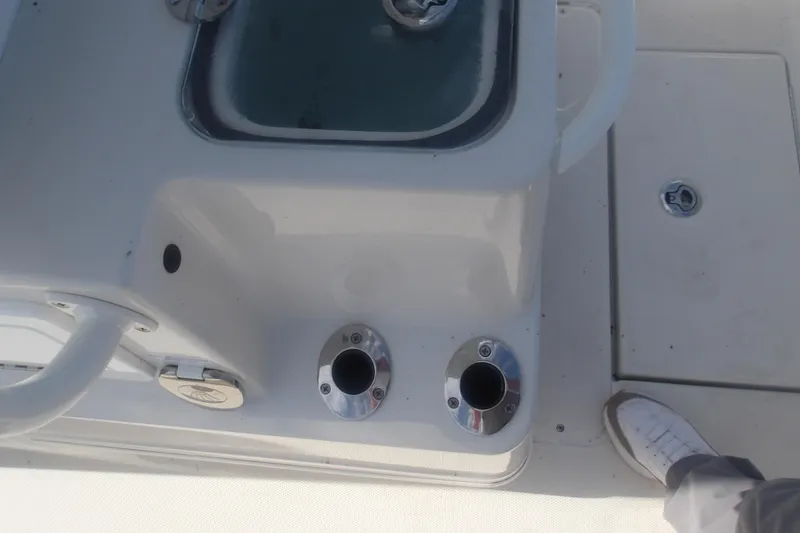Slide: The Image of 2025 Ranger 2360 Bay boat deck with rod holders and livewell. - 17