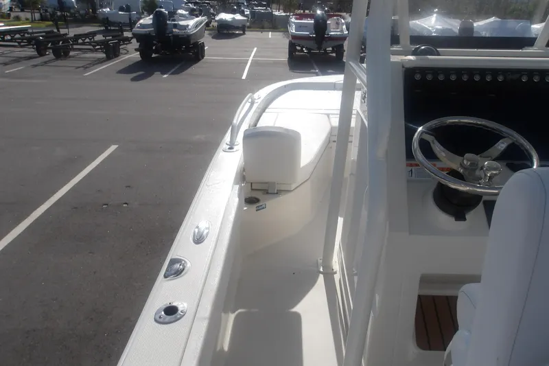 Slide: The Image of 2025 Ranger 2360 Bay boat interior with steering wheel, parked in a lot. - 4