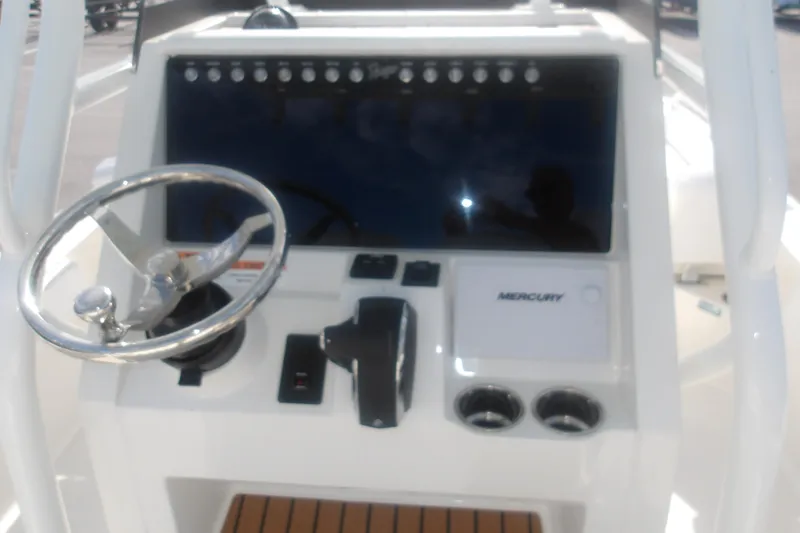 Slide: The Image of 2025 Ranger 2360 Bay boat dashboard with steering wheel and Mercury controls. - 21