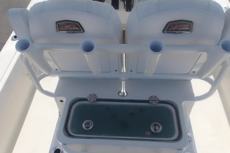 Slide: The Image of 2025 Ranger 2360 Bay boat interior with rod holders and storage compartment. - 13