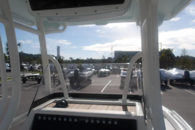 Slide: The Image of 2025 Ranger 2360 Bay boat dashboard view in a sunny parking lot. - 22