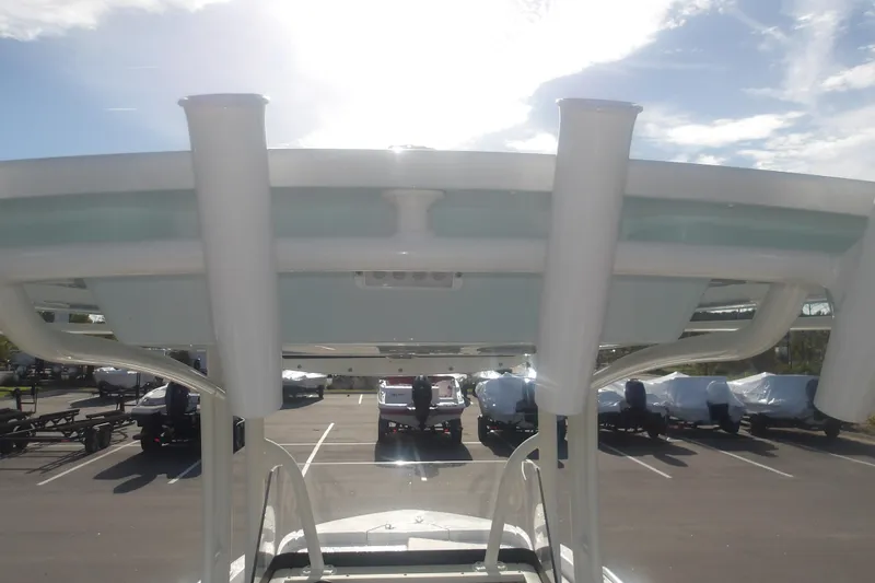 Slide: The Image of 2025 Ranger 2360 Bay boat with T-top, parked in a sunny lot. - 24