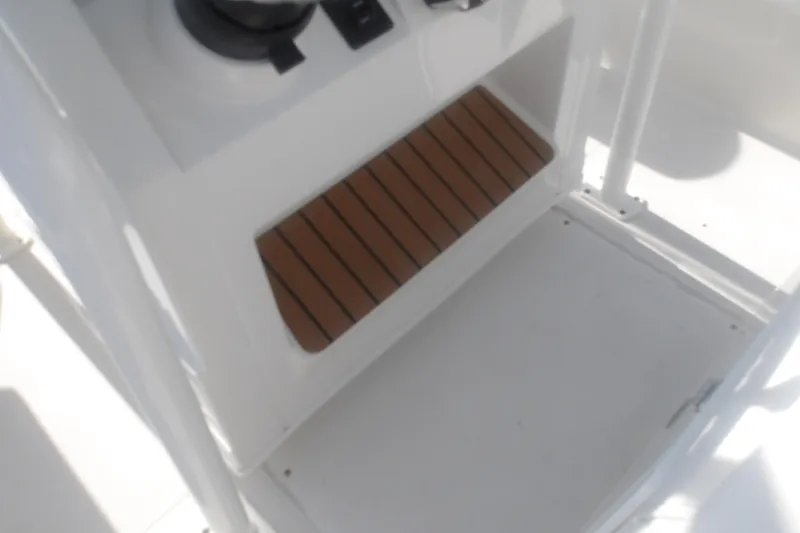 Slide: The Image of 2025 Ranger 2360 Bay boat interior with wooden step detail. - 18