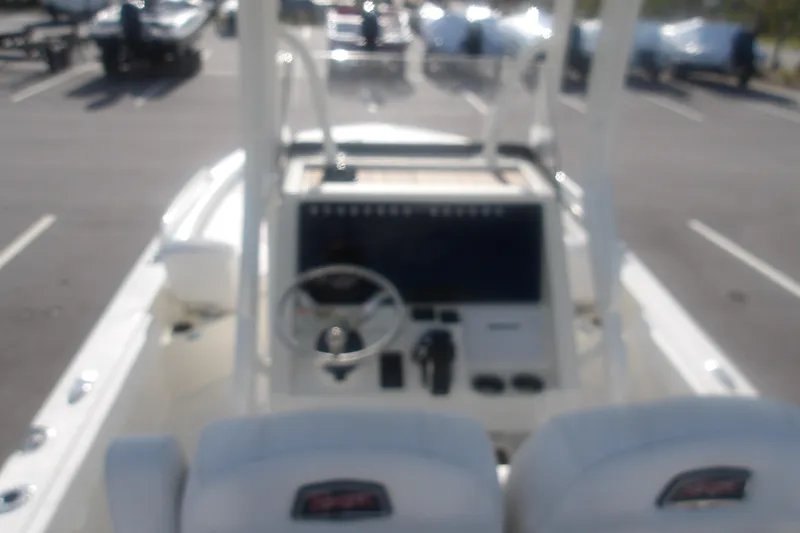 Slide: The Image of Blurry view of a 2025 Ranger 2360 Bay boat dashboard in a parking lot. - 19