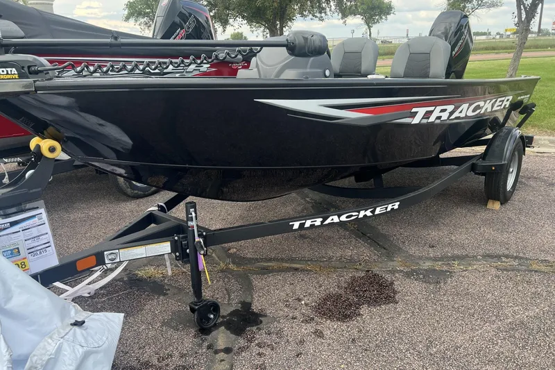 The Image of 2026 Tracker Super Guide V-16 SC boat on trailer, black with red accents. - 0