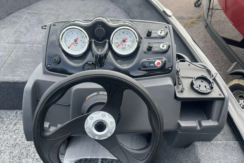 Slide: The Image of Steering console of 2026 Tracker Super Guide V-16 SC boat with gauges and controls. - 4