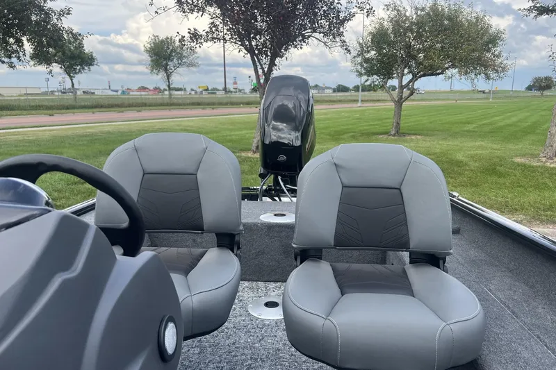 Slide: The Image of 2026 Tracker Super Guide V-16 SC boat interior with two gray seats and steering wheel. - 5