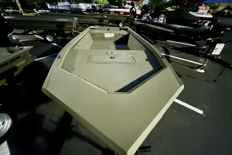 Slide: The Image of 2026 Tracker Grizzly 1648 Utility boat displayed outdoors at night. - 2