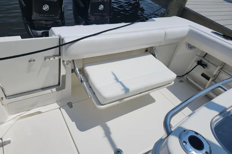 Slide: The Image of 2016 Boston Whaler 250 Outrage boat interior with seating and engine view. - 10