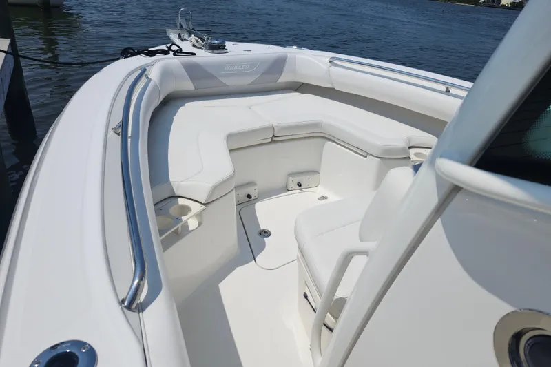 Slide: The Image of 2016 Boston Whaler 250 Outrage boat interior with white seating and cup holders. - 11