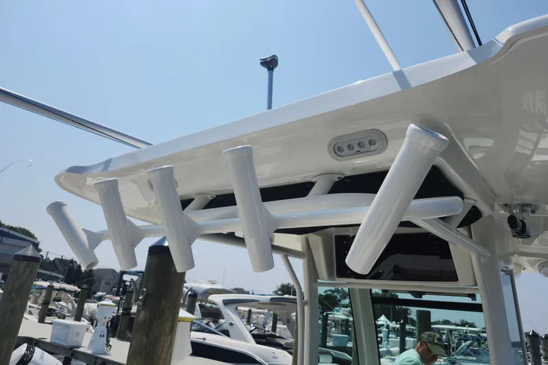 Slide: The Image of 2016 Boston Whaler 250 Outrage boat with rod holders and overhead lighting. - 14
