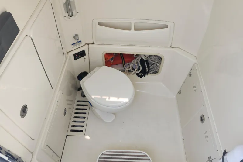 Slide: The Image of Interior of 2016 Boston Whaler 250 Outrage boat with toilet and storage compartment. - 16