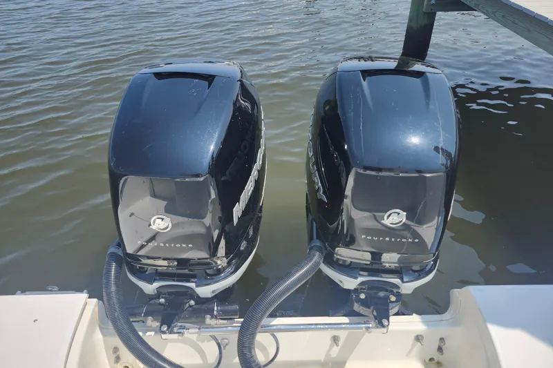 Slide: The Image of Twin Mercury outboard engines on a 2016 Boston Whaler 250 Outrage boat. - 17
