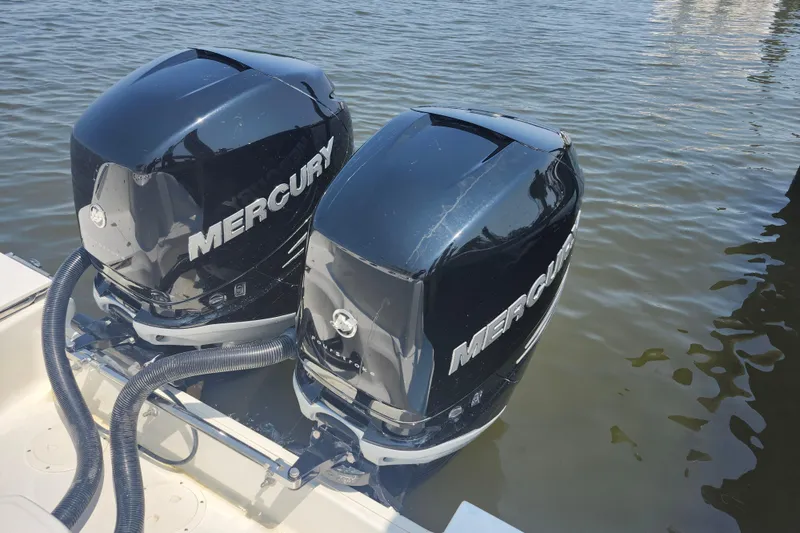 Slide: The Image of Twin Mercury outboard engines on a 2016 Boston Whaler 250 Outrage boat. - 19
