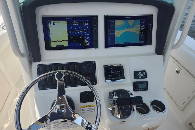 Slide: The Image of Control panel of 2016 Boston Whaler 250 Outrage with dual Simrad displays. - 4