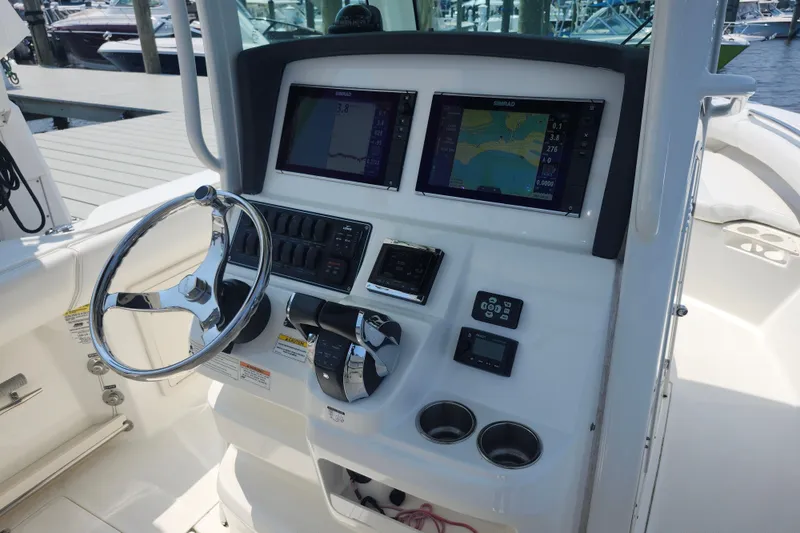 Slide: The Image of Helm of 2016 Boston Whaler 250 Outrage with navigation screens and controls. - 5