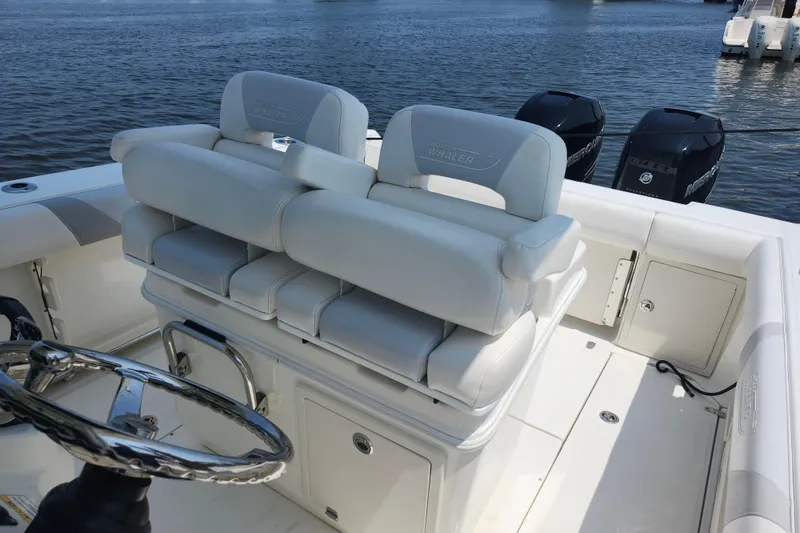 Slide: The Image of 2016 Boston Whaler 250 Outrage boat interior with dual seats and steering wheel. - 7