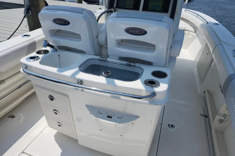 Slide: The Image of 2016 Boston Whaler 250 Outrage boat interior with seating and storage compartments. - 8