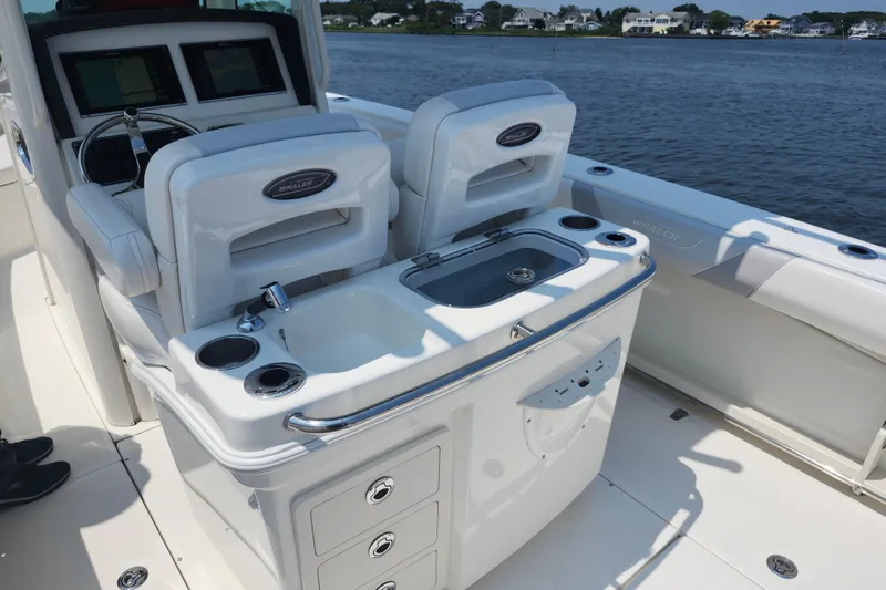 Slide: The Image of 2016 Boston Whaler 250 Outrage boat interior with helm and seating area. - 9