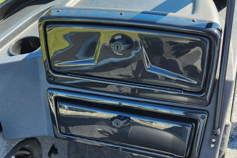 Slide: The Image of 2026 Tracker Targa V-18 Combo boat dashboard with storage compartments. - 12