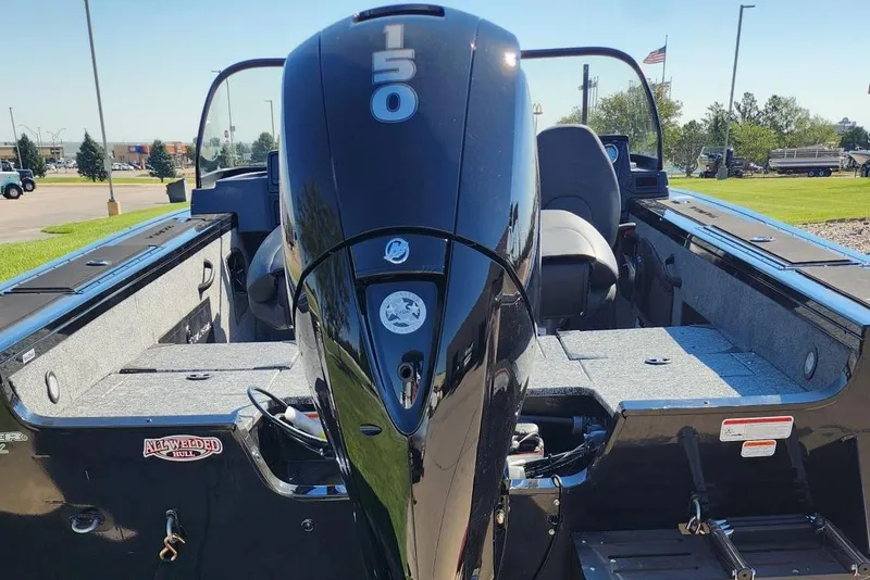 Slide: The Image of 2026 Tracker Targa V-18 Combo boat with powerful 150 HP engine, parked outdoors. - 5