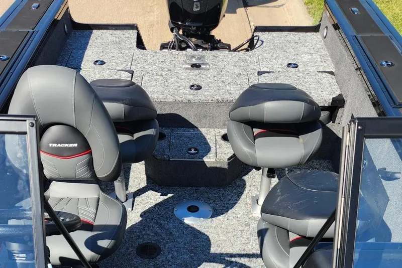 Slide: The Image of 2026 Tracker Targa V-18 Combo boat interior with gray seating and carpeted deck. - 7