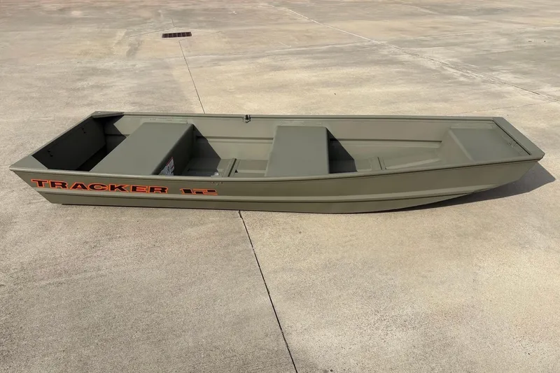 Slide: The Image of 2026 Tracker Grizzly 12 Jon boat on concrete surface, showcasing its sturdy design. - 1