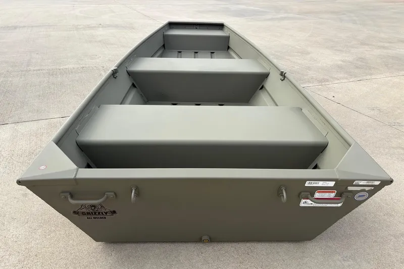 Slide: The Image of 2026 Tracker Grizzly 12 Jon boat, olive green, on concrete surface. - 3