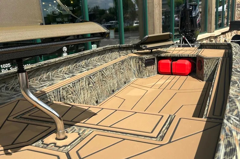 Slide: The Image of 2026 Tracker Grizzly 1650 T Prairie Wings Edition boat interior with camouflage design. - 2