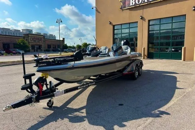 Slide: The Image of 2025 Ranger Z521R Cup-Equipped boat on trailer outside dealership, sunny day. - 3
