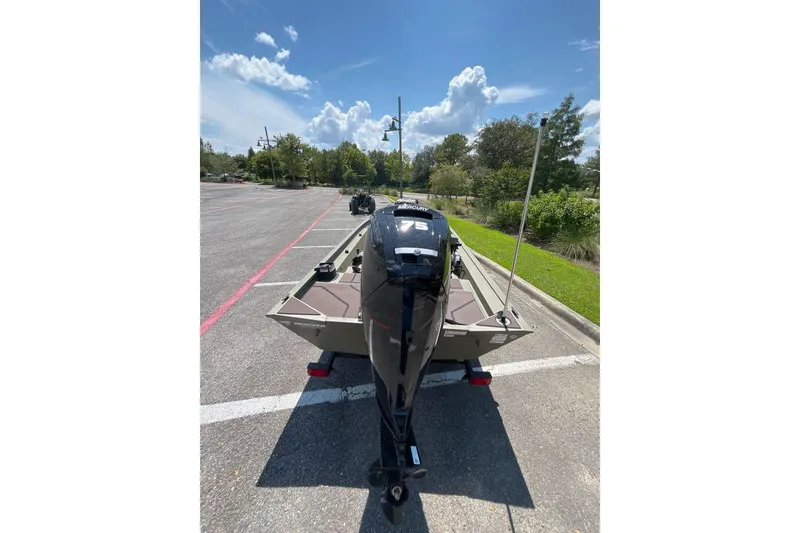 Slide: The Image of 2026 Tracker Grizzly 1754 SC boat with Mercury 75 engine in parking lot. - 2