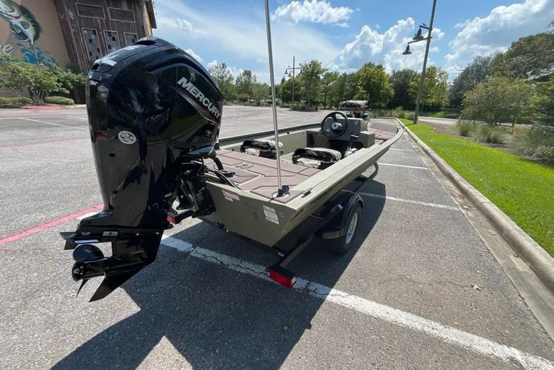 Slide: The Image of 2026 Tracker Grizzly 1754 SC boat with Mercury engine in parking lot. - 3