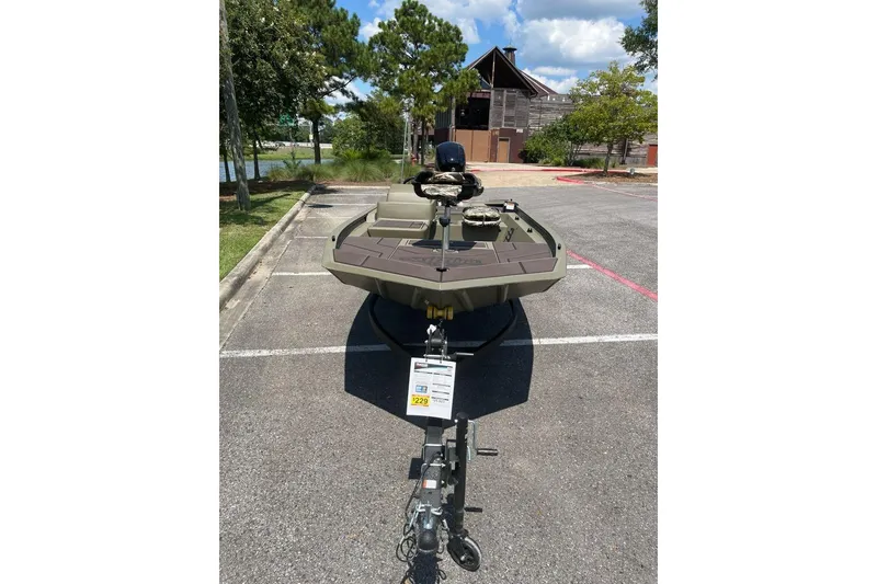 Slide: The Image of 2026 Tracker Grizzly 1754 SC boat parked outdoors, showcasing its sturdy design and trailer. - 6