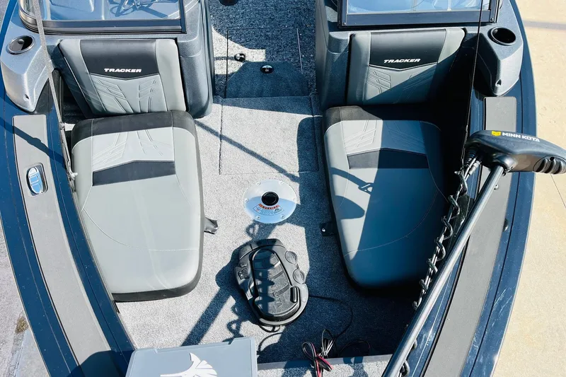 Slide: The Image of 2026 Tracker Targa V-18 Combo boat interior with seating and Minn Kota trolling motor. - 18