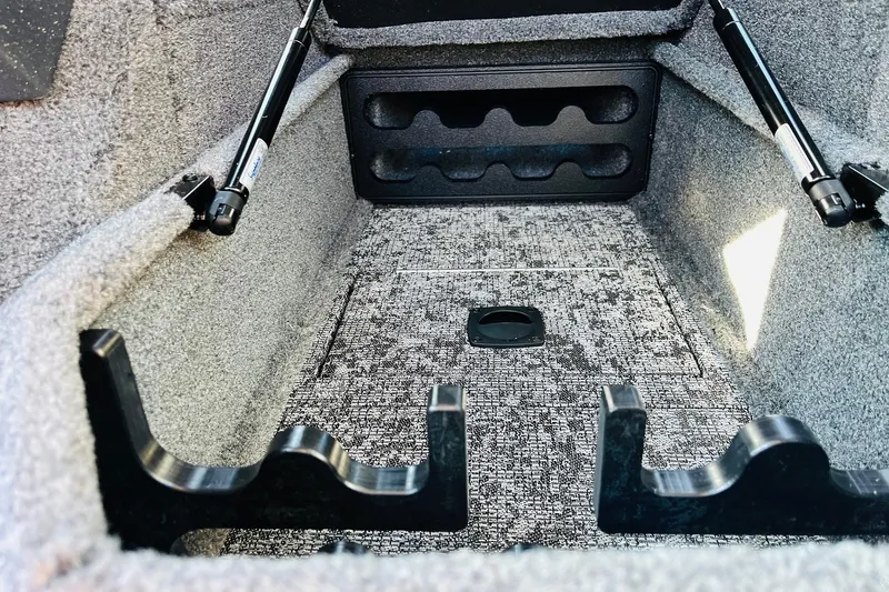 Slide: The Image of Interior storage compartment of 2026 Tracker Targa V-18 Combo boat, featuring carpeted finish. - 29