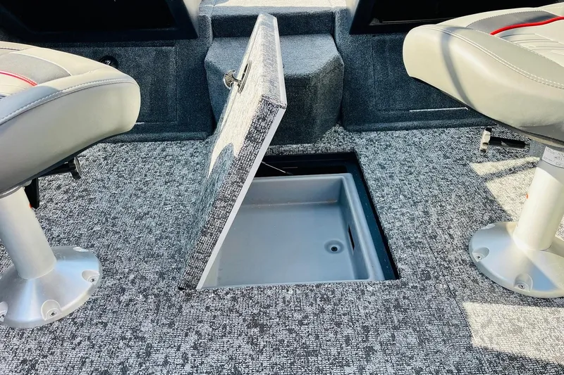 Slide: The Image of 2026 Tracker Targa V-18 Combo boat interior with open storage compartment and seating. - 30