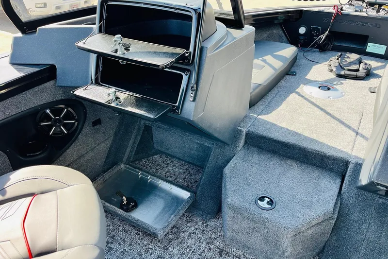 Slide: The Image of 2026 Tracker Targa V-18 Combo boat interior with storage compartments and seating. - 35