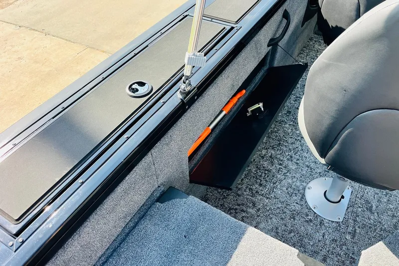 Slide: The Image of 2026 Tracker Targa V-18 Combo interior with storage compartment and seating. - 37