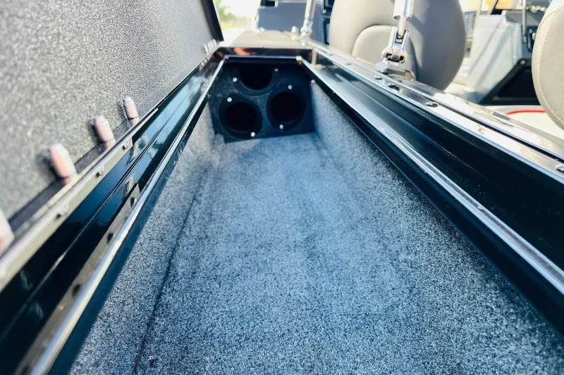 Slide: The Image of 2026 Tracker Targa V-18 Combo boat interior storage compartment with carpeted finish. - 39