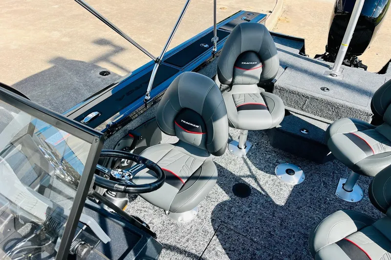 Slide: The Image of 2026 Tracker Targa V-18 Combo boat interior with gray seating and steering wheel. - 40