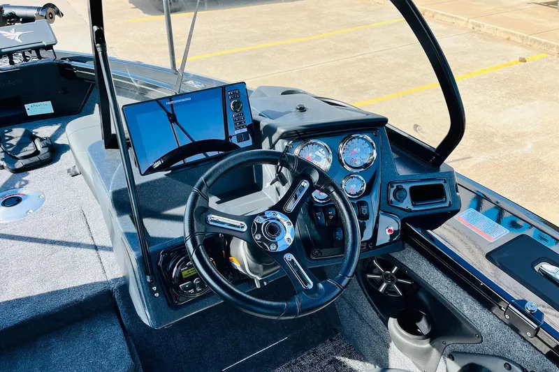 Slide: The Image of 2026 Tracker Targa V-18 Combo boat dashboard with steering wheel and navigation display. - 43