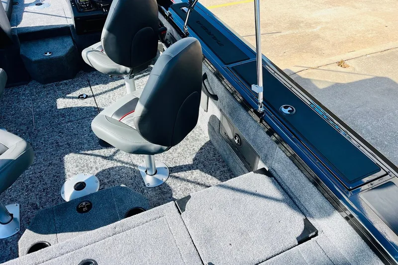 Slide: The Image of 2026 Tracker Targa V-18 Combo boat interior with gray seating and carpeted flooring. - 49