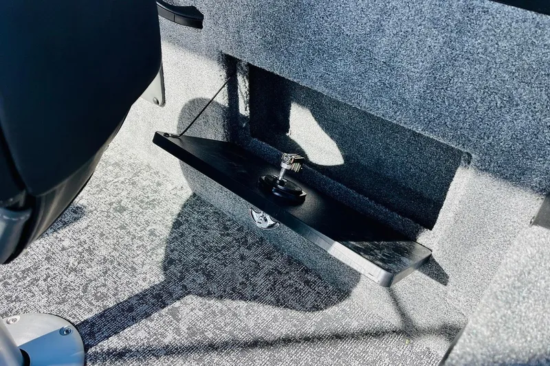 Slide: The Image of Interior of 2026 Tracker Targa V-18 Combo boat, featuring carpeted flooring and storage compartment. - 50