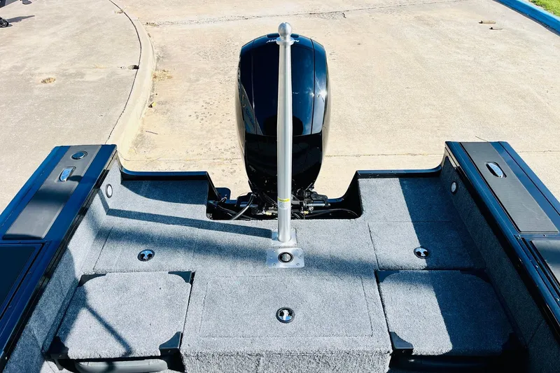 Slide: The Image of 2026 Tracker Targa V-18 Combo boat interior with motor, featuring spacious deck and storage compartments. - 55