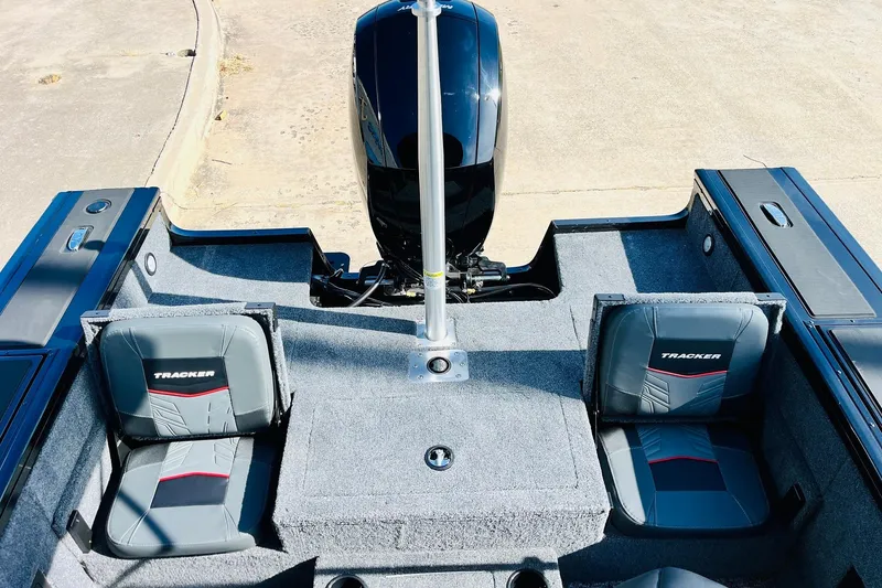 Slide: The Image of 2026 Tracker Targa V-18 Combo boat interior with dual seats and motor. - 56