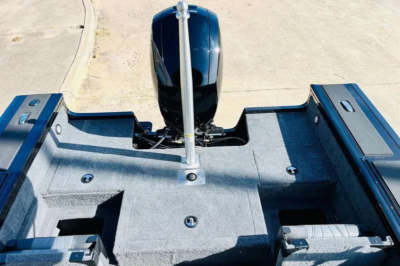 Slide: The Image of 2026 Tracker Targa V-18 Combo boat interior with motor, showcasing spacious deck design. - 59